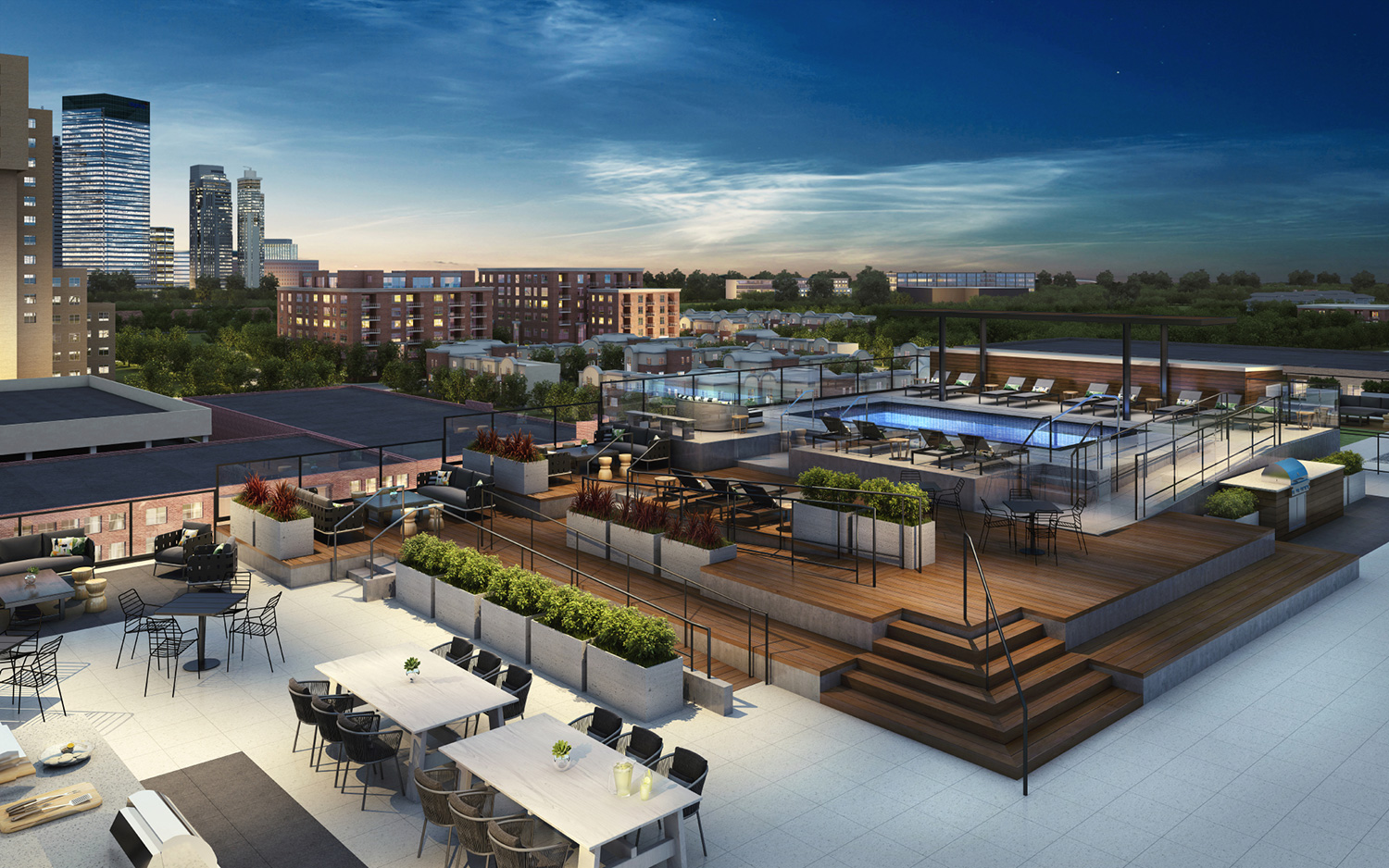 MDU sundeck with pools and chairs lit up at night