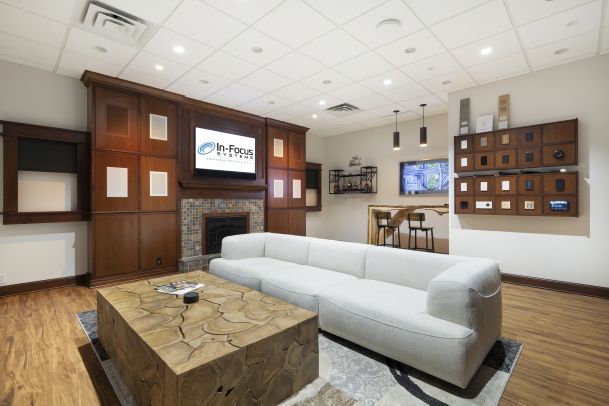 Bright living demo room with sofa, TV wall, and control panel display