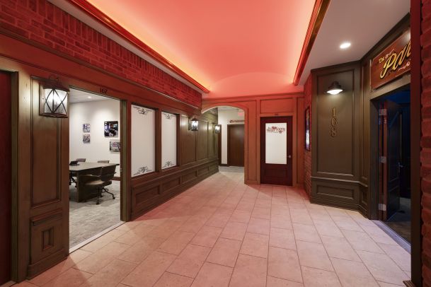 Hallway with red ceiling lighting and decorative wall panels