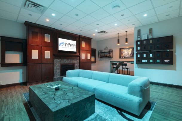 Smart living space with sofa, wood coffee table, and control display wall