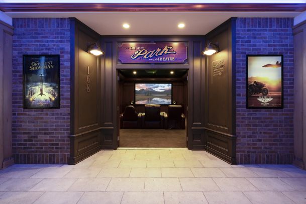 Home theater entrance with movie posters and seating inside