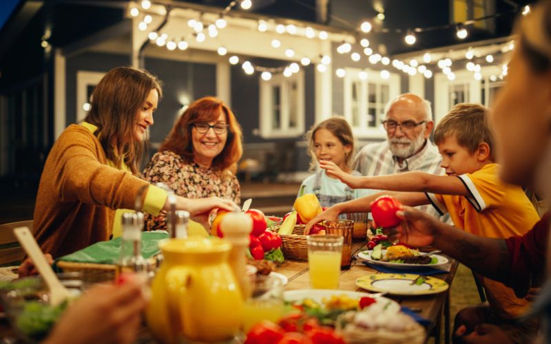<span class="uk-h4">A family enjoys a meal under the stars on an outdoor patio.</span>
