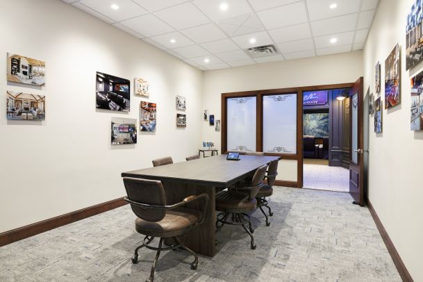 Meeting room with long conference table and wall gallery