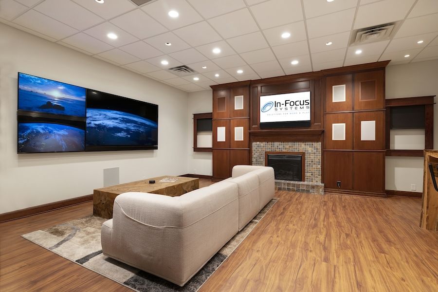 In-Focus Systems’ showroom showing a luxury couch and wall-mounted TV displays